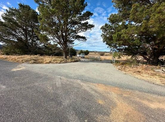 Freshly sealed bitumen driveway entrance