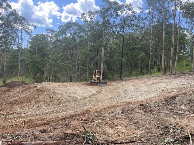 Caterpillar D3G dozer clearing and cutting a building pad on a rural property, Northern NSW