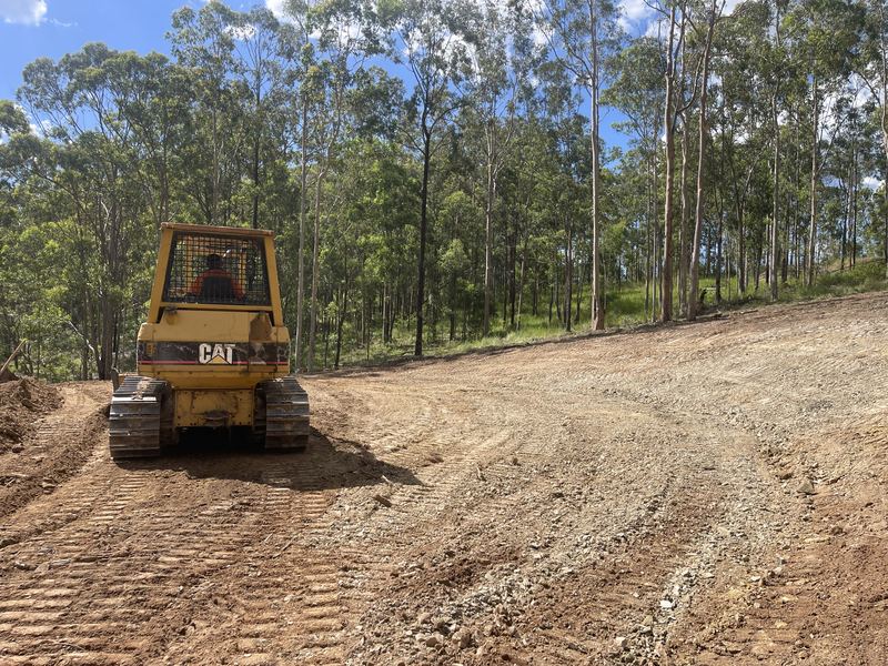 Caterpillar D3G dozer on a freshly cut pad on a rural property